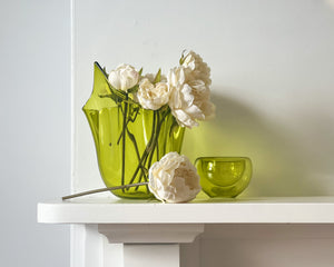 cream peony flowers on a white surface against a light gray background