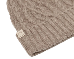 Beige knitted beanie with a brand label on a white background